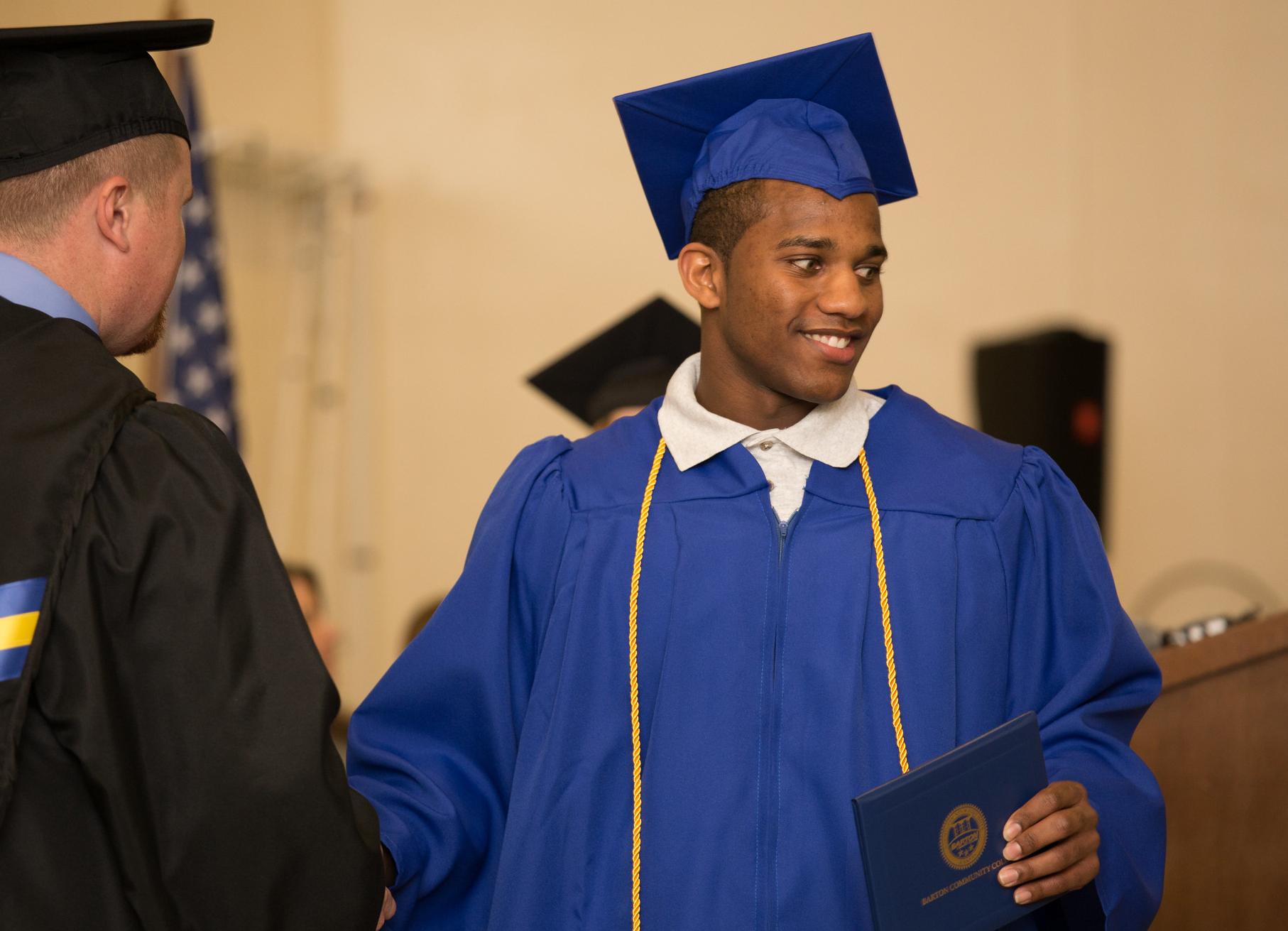 cap and gown resident with diploma