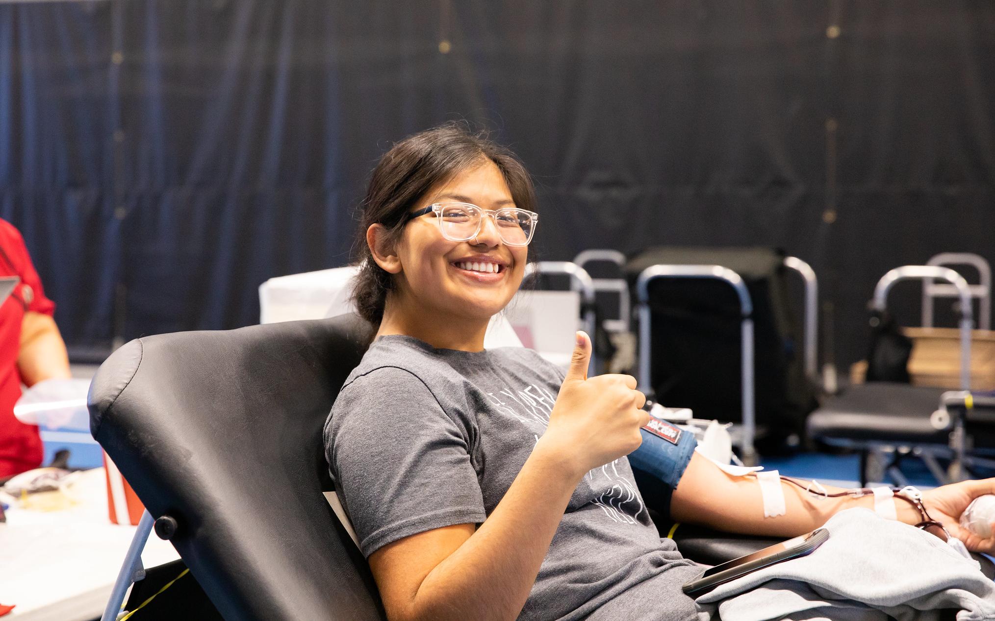 women giving a thumbs up while donating blood