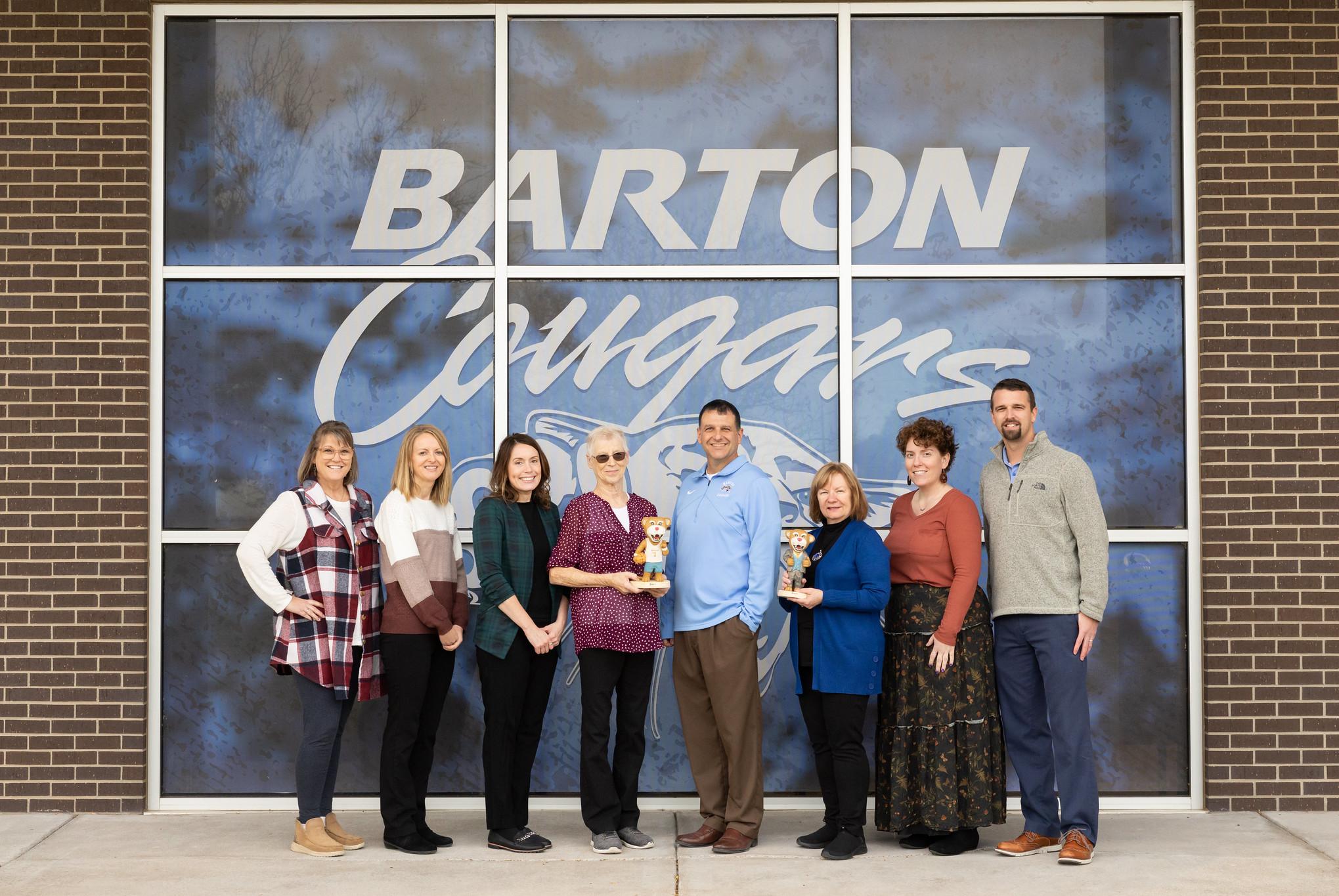 people holding statues of small cougars
