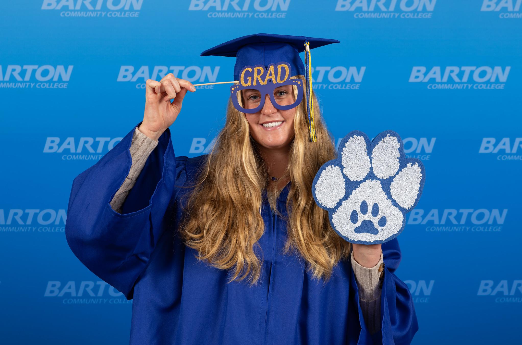 women in graduate gown with props