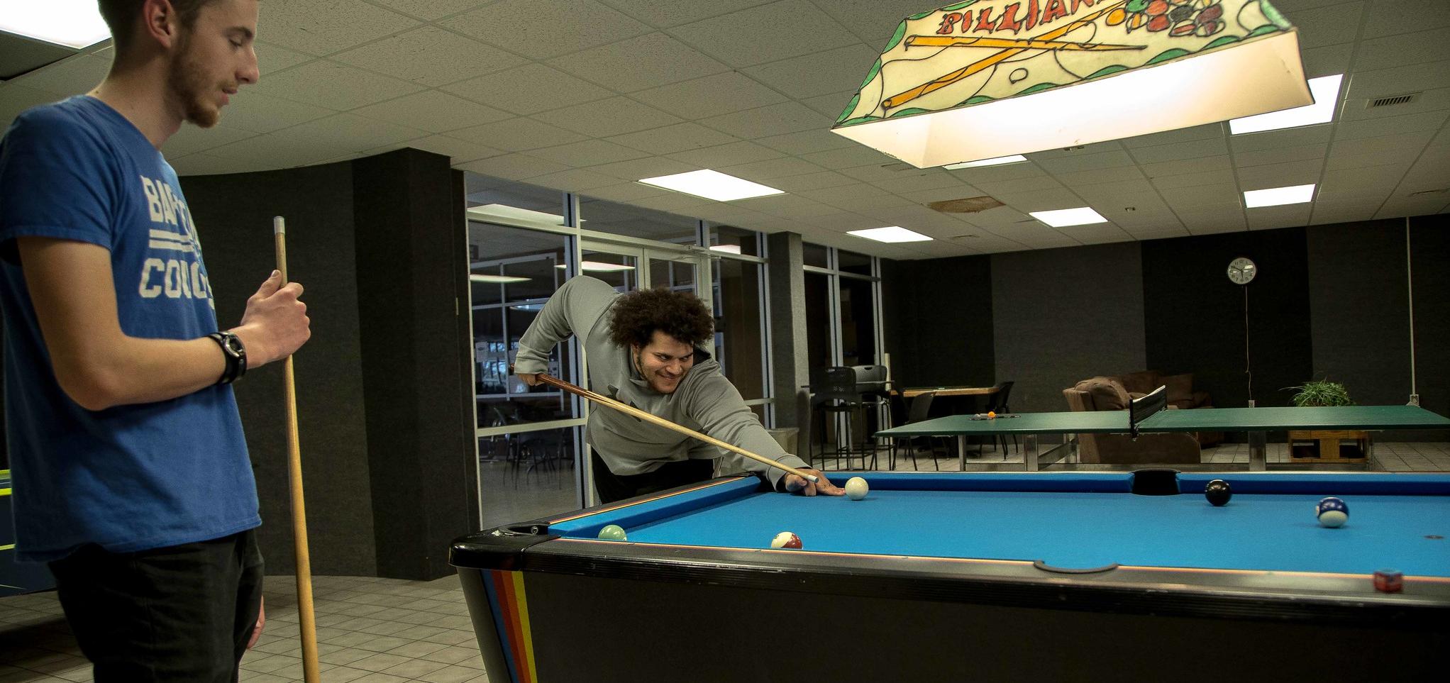 Students play pool in Student Union