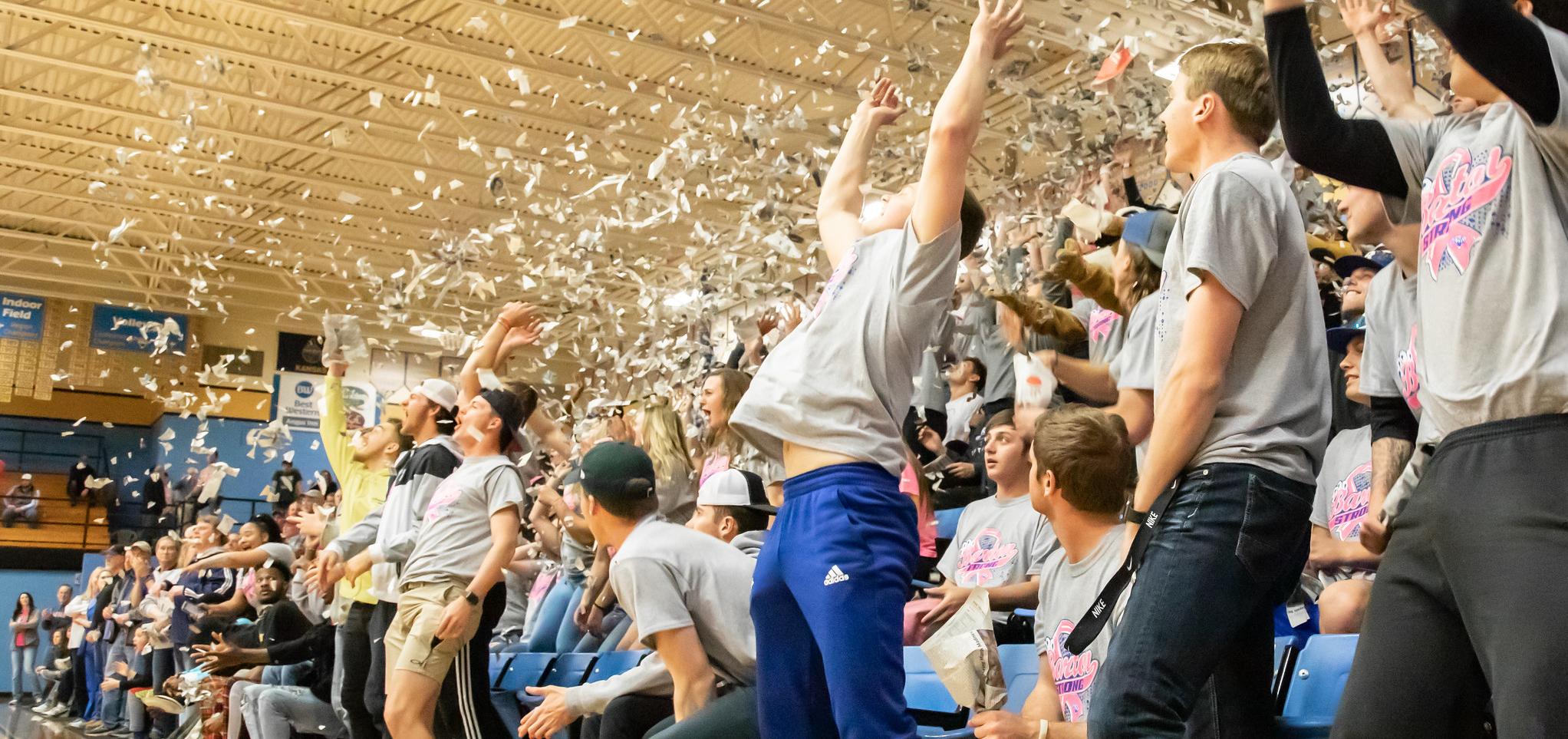 Students celebrate the tip off at a basketball game