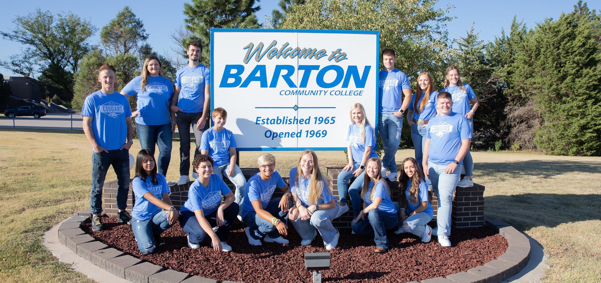 Barton Student Ambassadors pose by the Barton Welcome sign