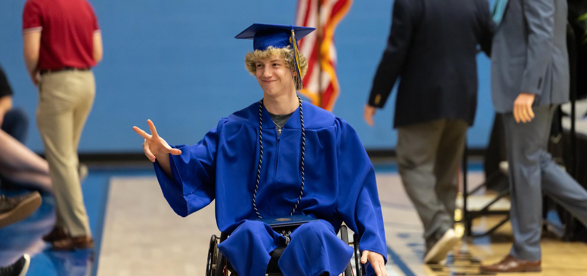 A student holds diploma after graduating