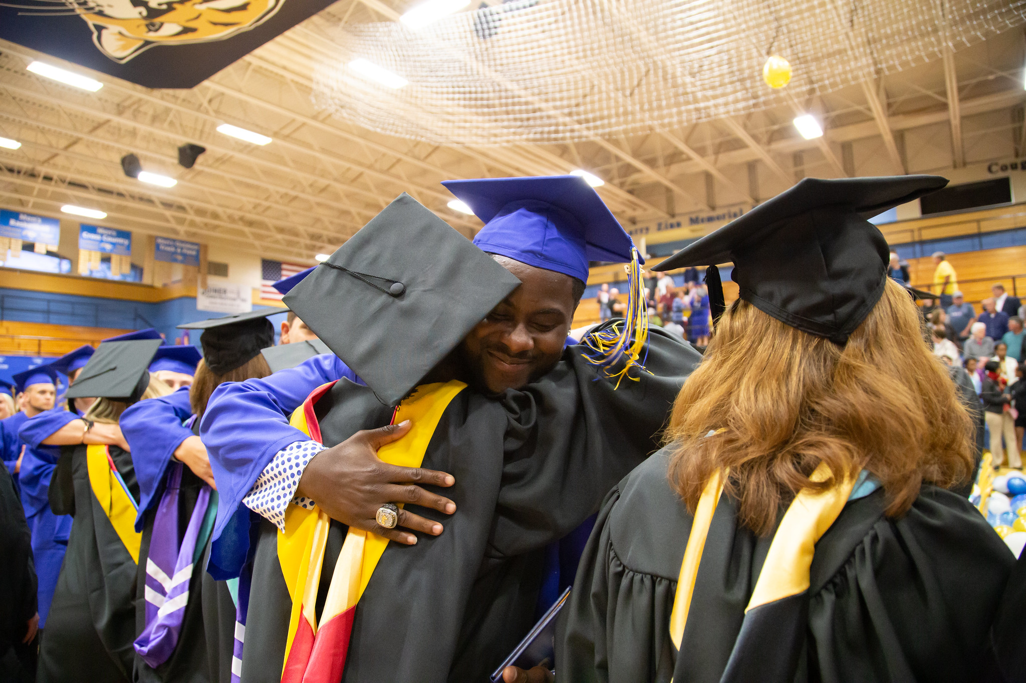 student and teacher embrace