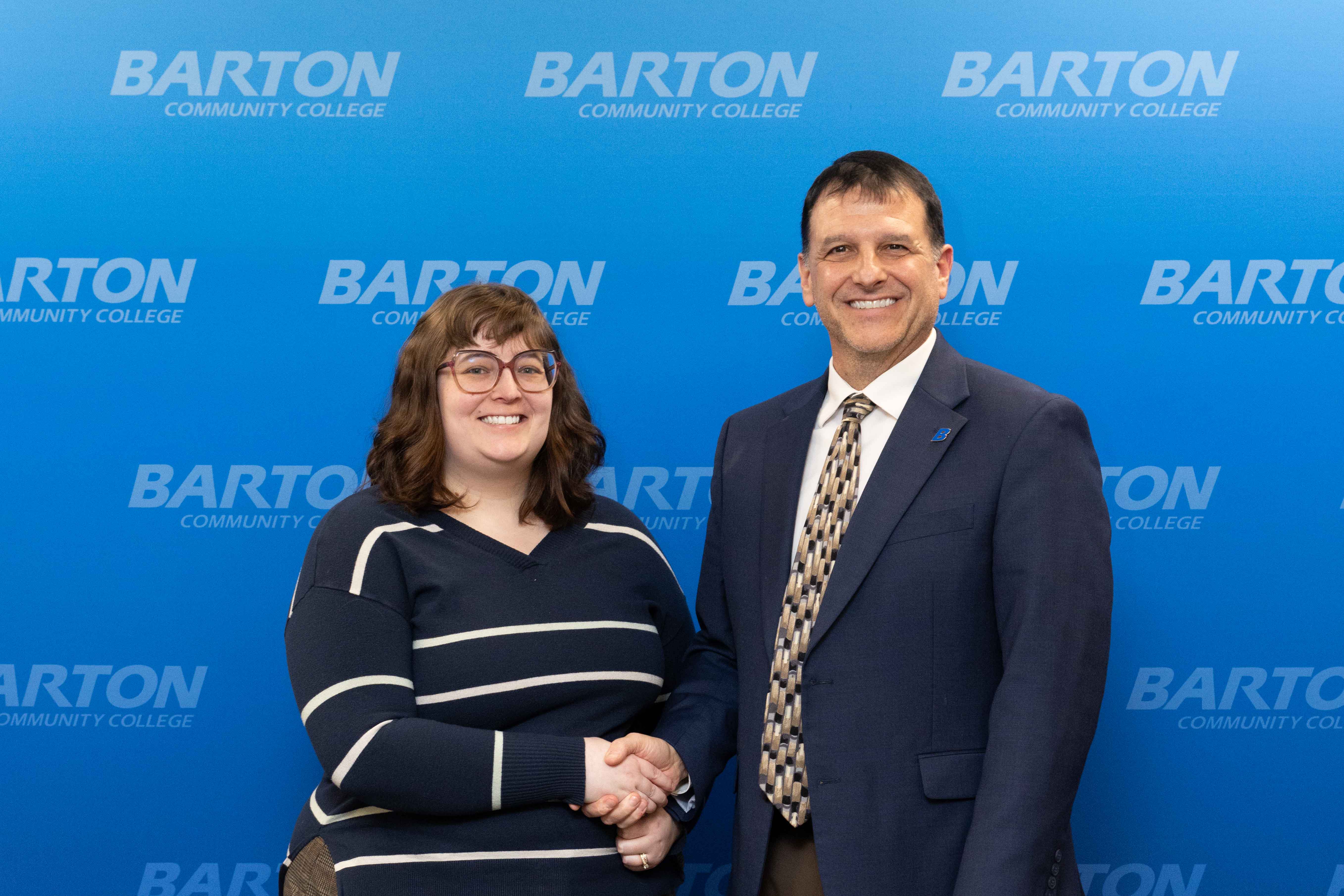 man shaking woman's hand