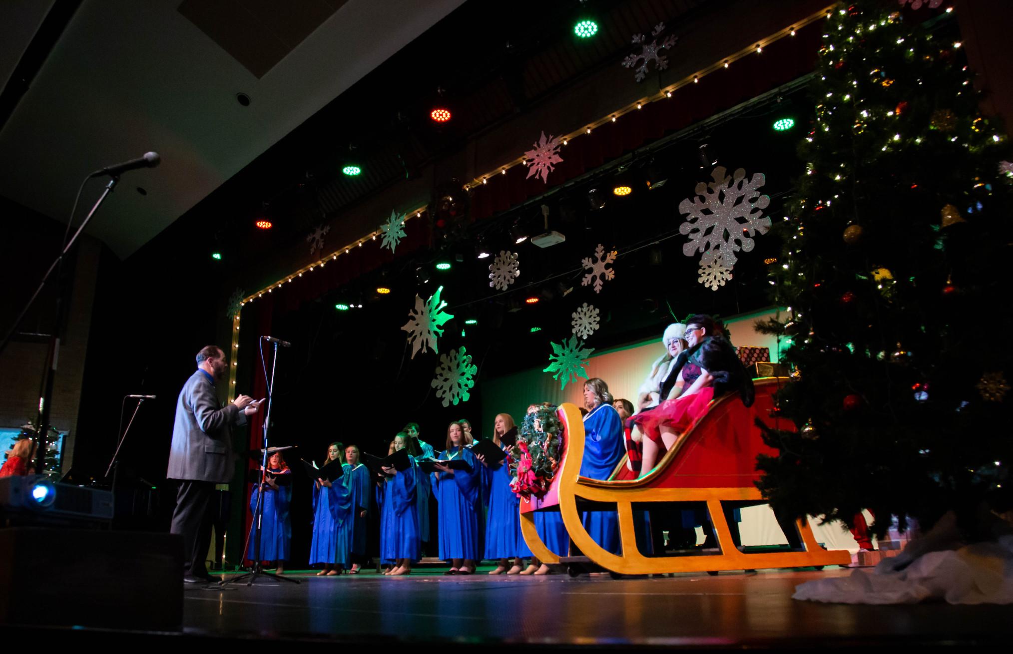 students sing on a christmas decorated stage