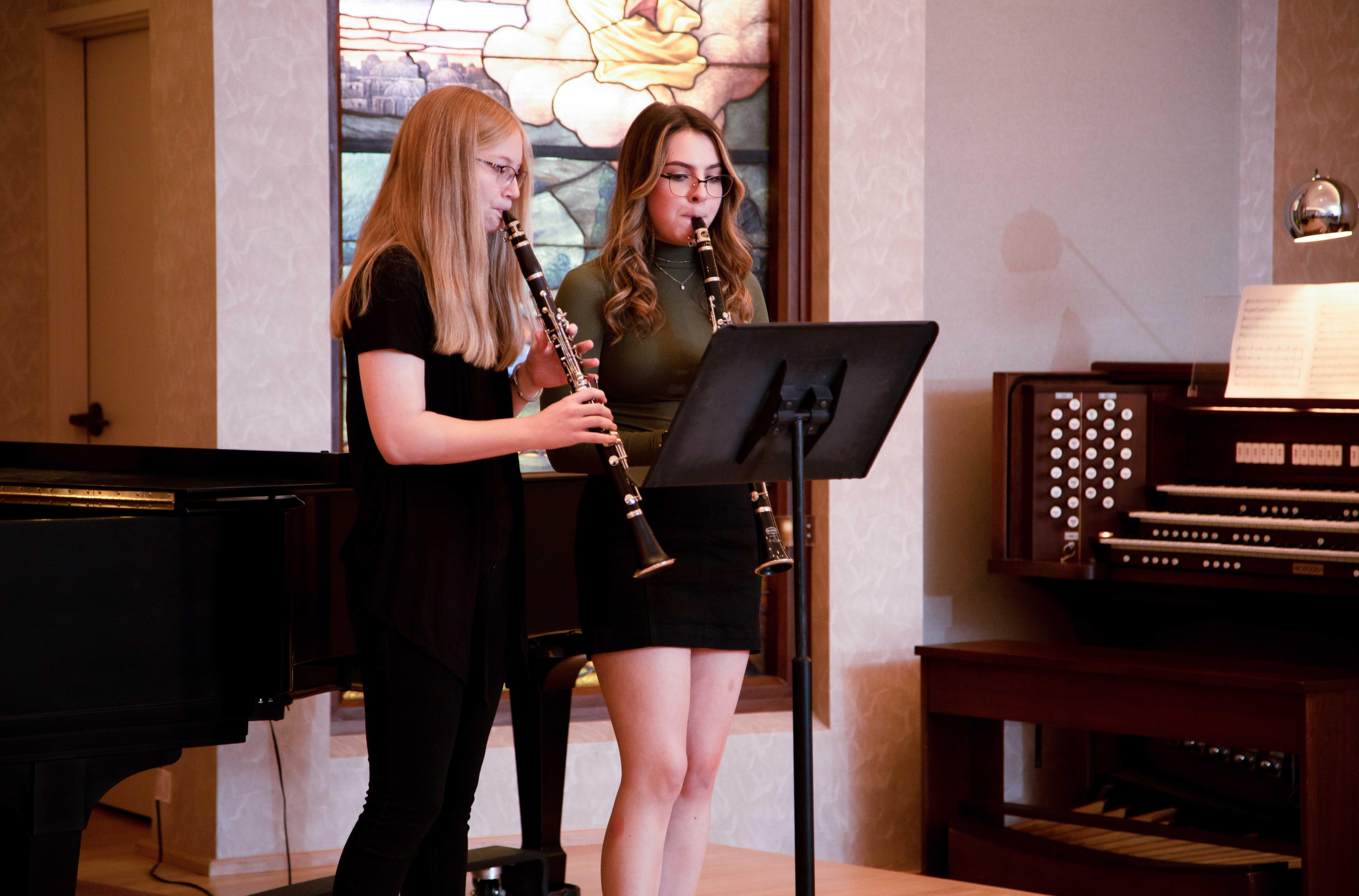 two students playing clarinets