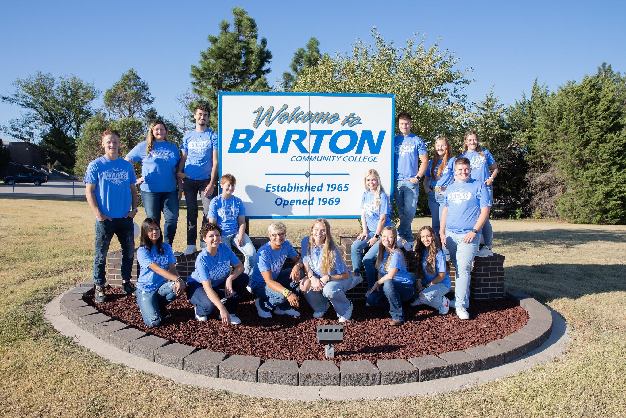Barton Student Ambassadors pose by the Barton Welcome sign