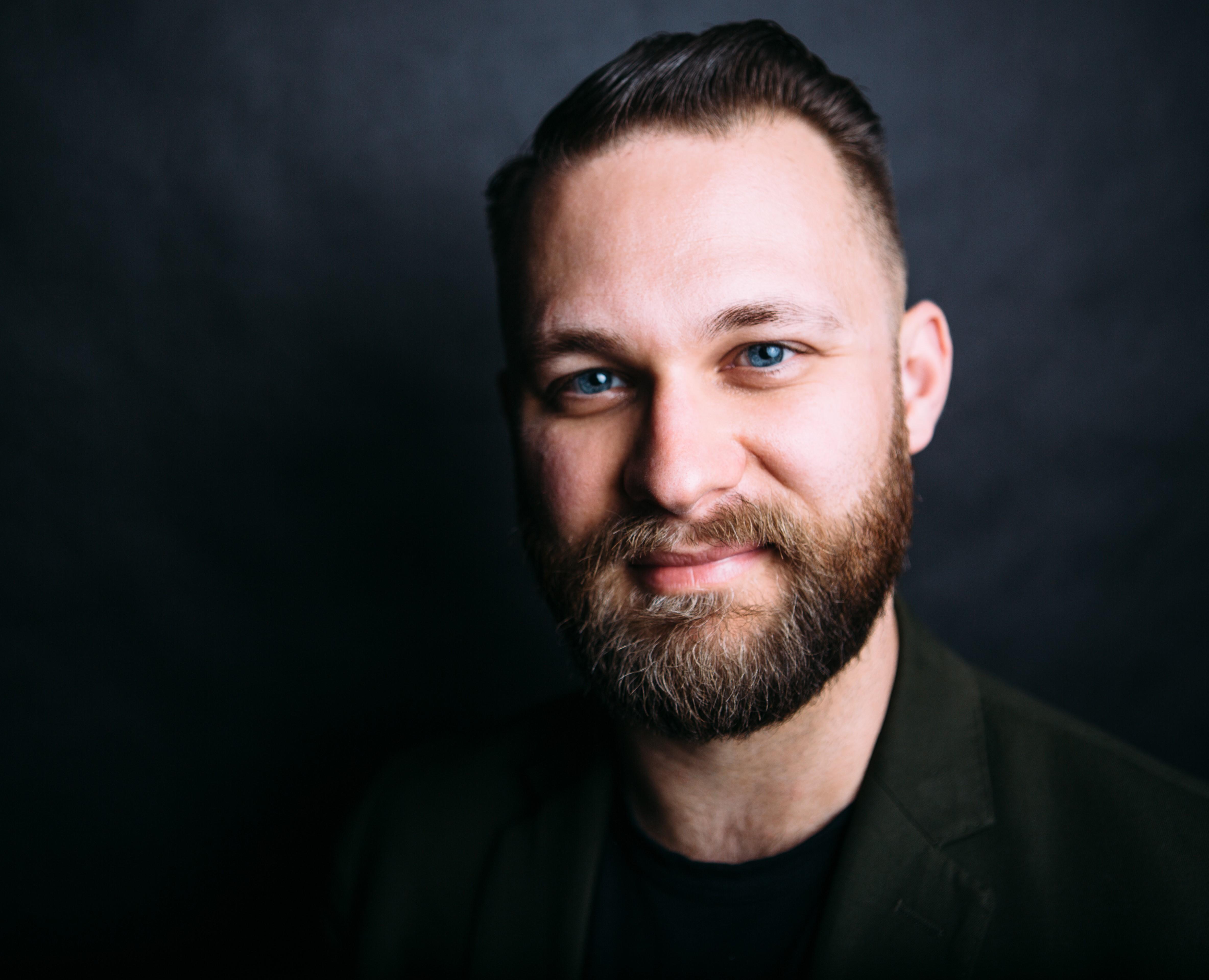 portrait of a man with brown hair and a beard