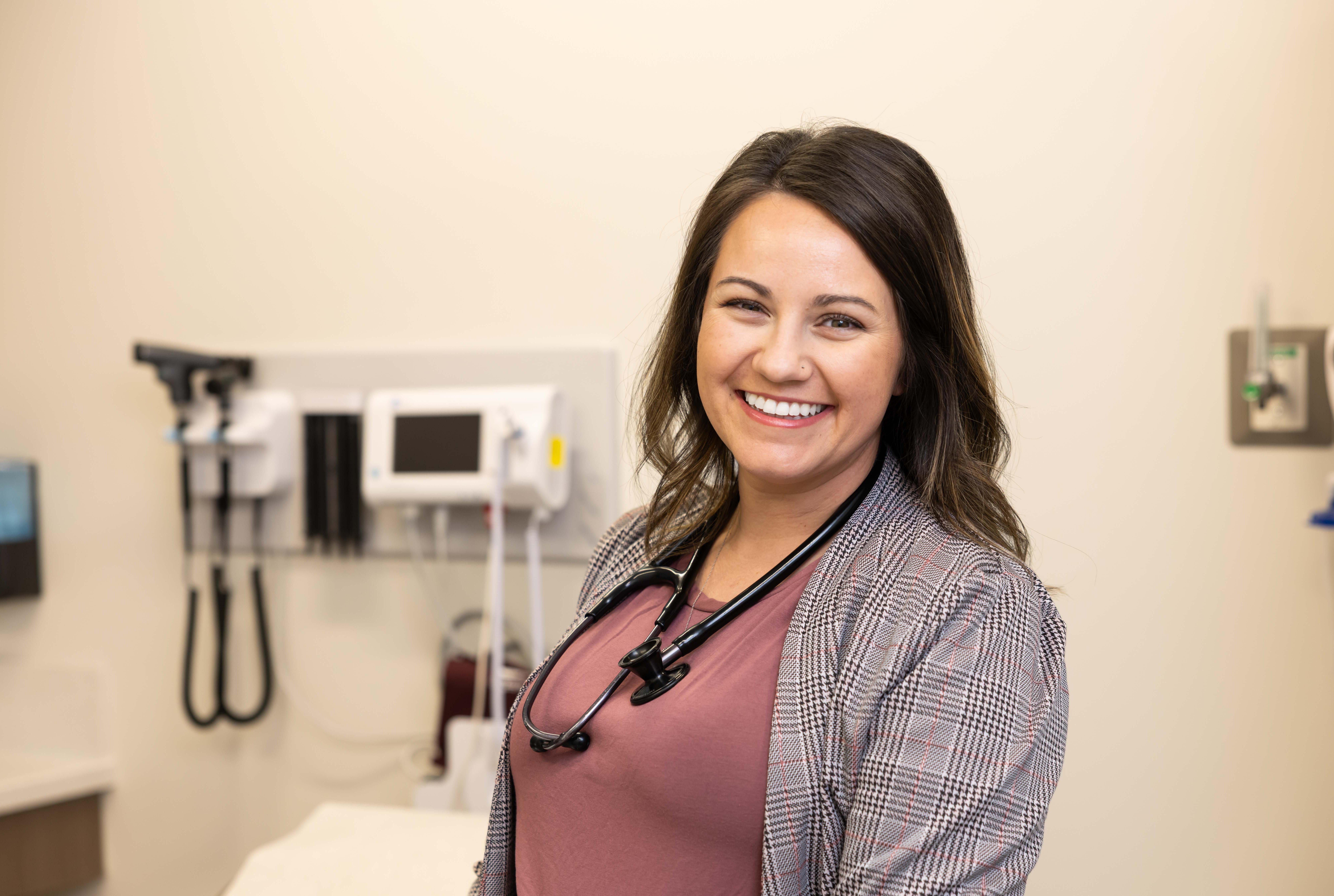 smiling nurse with stethoscope on