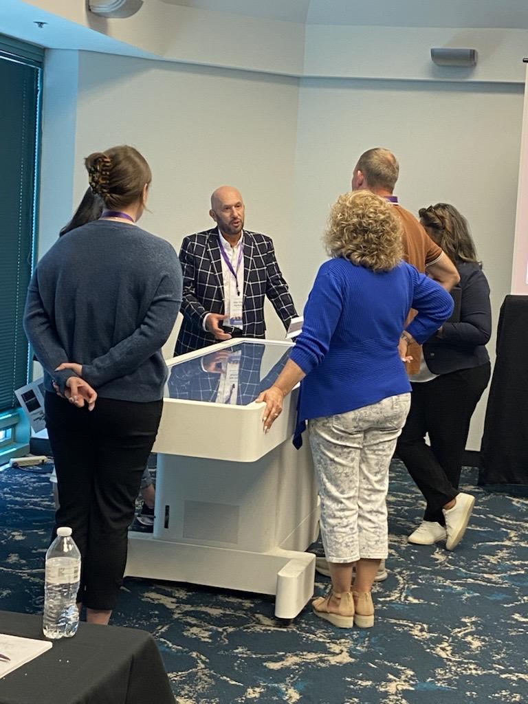 man using interactive video table at conference