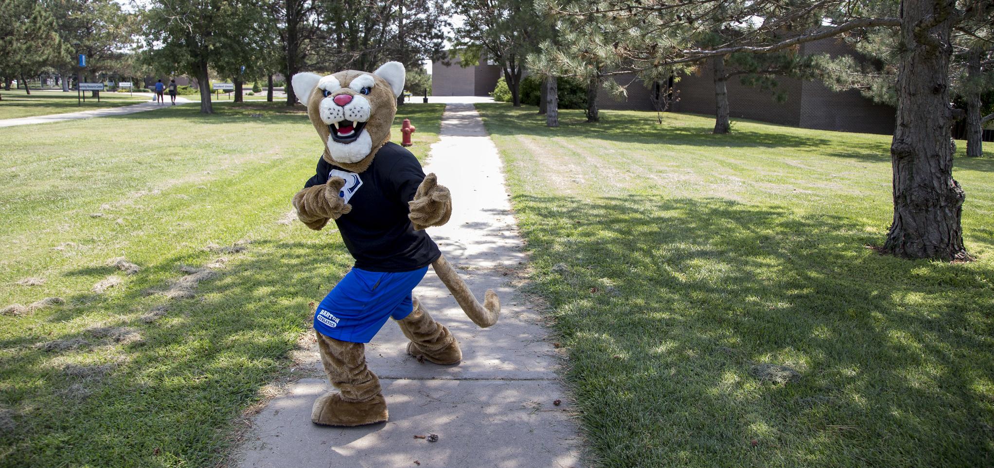 Bart gives thumbs up while walking on campus
