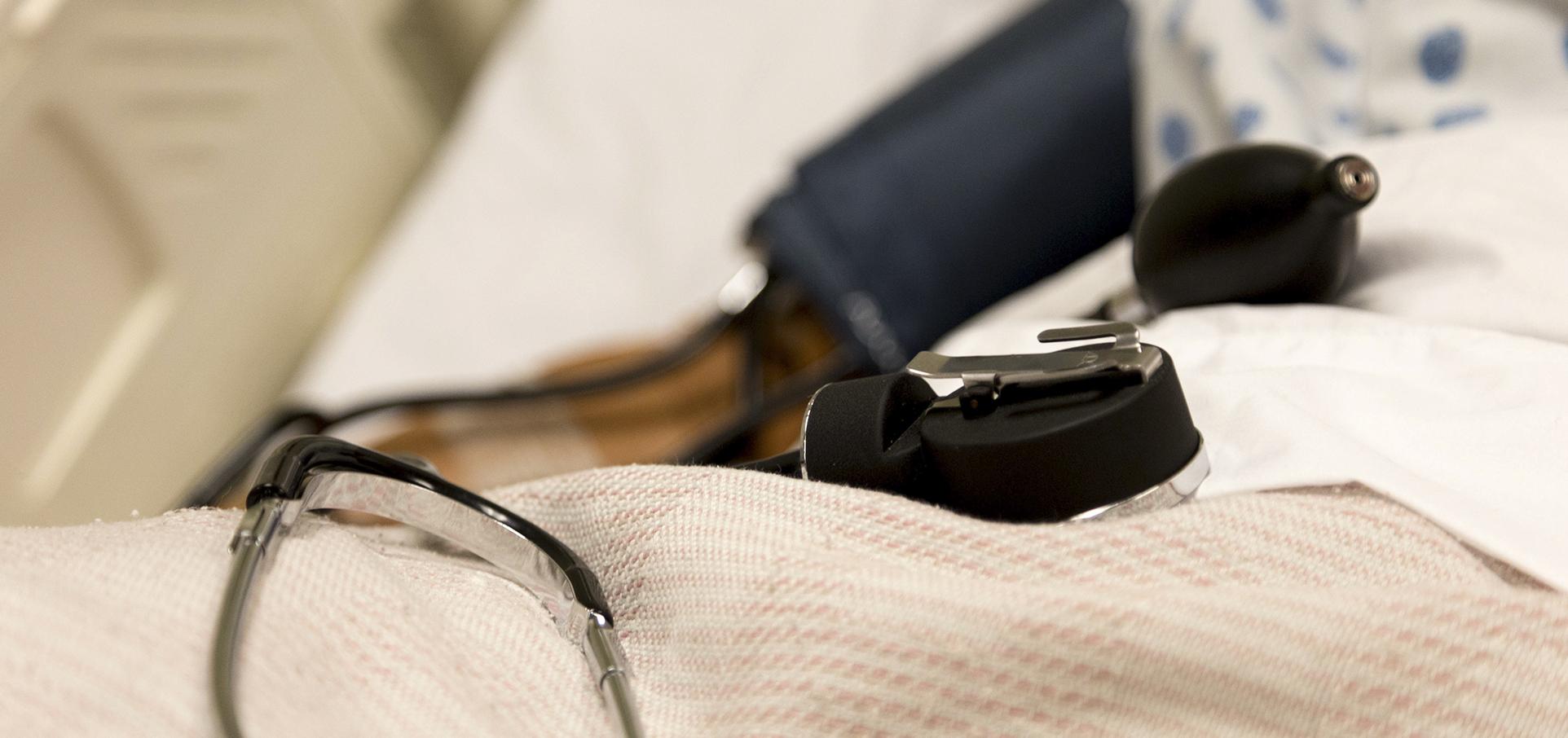 blood pressure cuff on patient bed