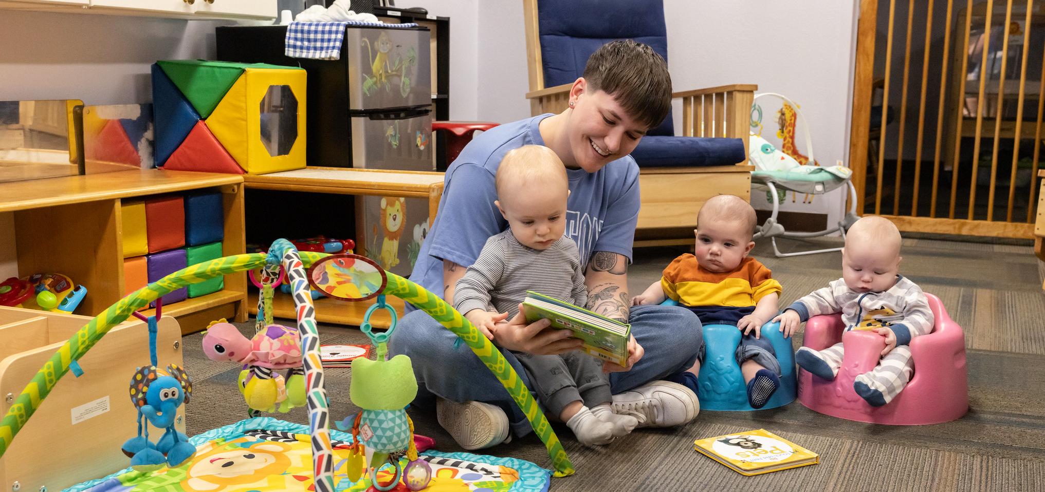Early childhood barton student reads to toddlers at Barton